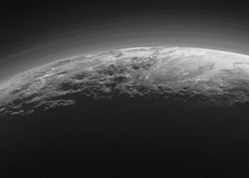 Just 15 minutes after its closest approach to Pluto on July 14, 2015, NASA's New Horizons spacecraft looked back toward the sun and captured this near-sunset view of the rugged, icy mountains and flat ice plains extending to Pluto's horizon. The smooth expanse of the informally named icy plain Sputnik Planum (right) is flanked to the west (left) by rugged mountains up to 11,000 feet (3,500 meters) high, including the informally named Norgay Montes in the foreground and Hillary Montes on the skyline. To the right, east of Sputnik, rougher terrain is cut by apparent glaciers. The backlighting highlights more than a dozen layers of haze in Pluto's tenuous but distended atmosphere. The image was taken from a distance of 11,000 miles (18,000 kilometers) to Pluto; the scene is 780 miles (1,250 kilometers) wide. Credit: NASA/Johns Hopkins University Applied Physics Laboratory/Southwest Research Institute